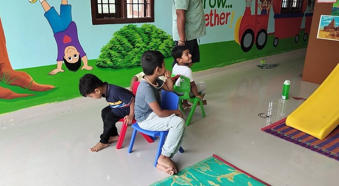 Indoor play area with slide and wall murals